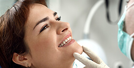 dentist holding up woman's smile
