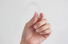 Patient holding clear aligner